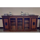 Late Victorian oak breakfront bookcase of Gillows style, with ebonised mouldings and inlay, fitted