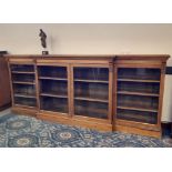 Late Victorian walnut breakfront low bookcase, fitted eight shelves enclosed by two pairs of