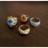 Four silver and silver gilt paste set rings, various sizes
