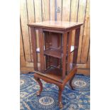 Edwardian mahogany square revolving bookcase, inlaid with chequered banding, on cabriole legs,