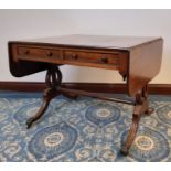 George IV figured mahogany sofa table, fitted two real and two dummy drawers, on reeded splayed