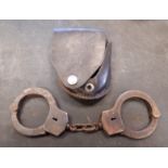 Pair early 20th Century American steel handcuffs by W. Darley & Co, Chicago, with leather pouch (