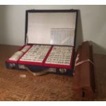 Chinese Mah Jong set, in blue fabric fitted case, together with four hardwood counter stands