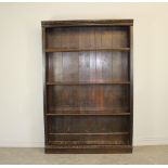 A large stained and carved pine bookcase with adjustable shelving 201cm x 135cm x 31cm