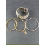 Two rolled-gold bangles, a 925 grade white metal bangle and an Eastern white metal bangle ,