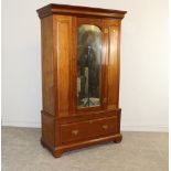 A Victorian mahogany mirror door wardrobe, with moulded cornice over an arched mirror door and