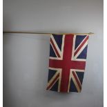 A vintage Union Flag, on a light wood pole 86cm x 55cm