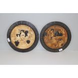 A pair of Bretby pottery circular wall plaques, relief moulded with traditional Japanese figural