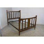 An Edwardian mahogany double bed with rails and base 134cm x 138cm x 200cm some staining etc.