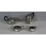 A planished English pewter four-piece teaset, teapot, hot water pot, sugar & milk jug (4)