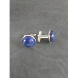 A pair of white metal and Lapis Lazuli cuff-links, with circular cabochons 2.3cm