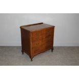 A reproduction figured mahogany chest of drawers, with four graduating drawers, the top drawer