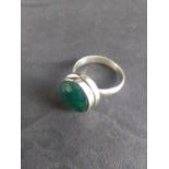 A white metal and emerald ring, ring size P.