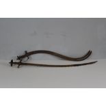 A pair of unusual Tulwar swords, one with curved and serrated blade 88cm and the other with
