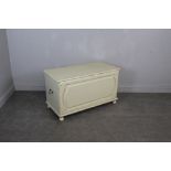 A cream-painted blanket box of continental design 59cm x 100cm x 48cm