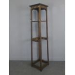 A tall early 20th century oak and brass coat stand 174cm x 41cm