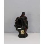 A figural bronzed resin mirror/clock with battery operated movement, by Juliana 49cm