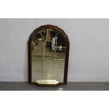 A modern mahogany and gilt effect arched top mirror with lead'-glazed effect and base shelf 107cm