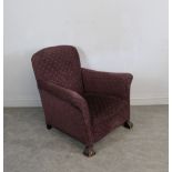 A 1920's/30's oak framed armchair, padded and re-upholstered in patterned purple material, carved