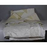 A machine stitched silk double bedspread and pillow cases, in shades of cream