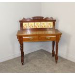 A Victorian mahogany washstand, the shaped surmount over a tile inset splash-back and rectangular