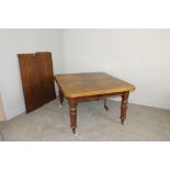 A Victorian mahogany wind-out extending dining table with moulded top on turned and reeded legs with