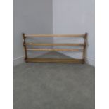A small Ercol elm wall mounted plate rack 47cm x 96cm