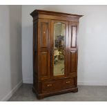 A Victorian panelled oak mirror door wardrobe, with bevelled plate and base drawer 199cm x 121cm x