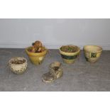 A composite stone boot garden planter and four various plant pots (5)