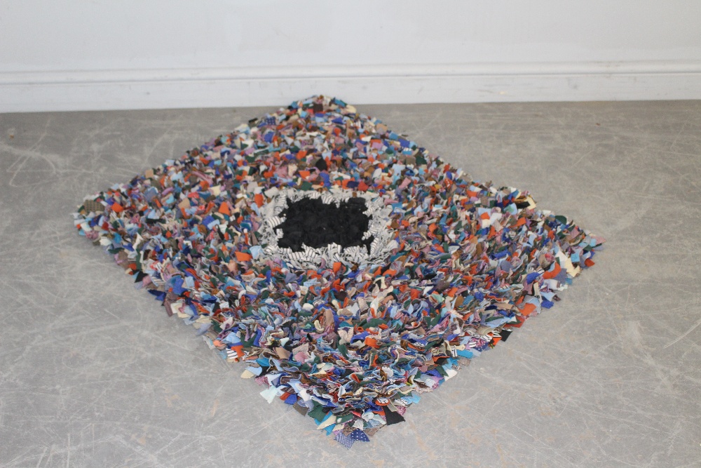 A small proddy or hooky rug, with central diamond lozenge 100cm x 80cm