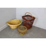 Three woven-wicker baskets, the largest measuring 70cm high