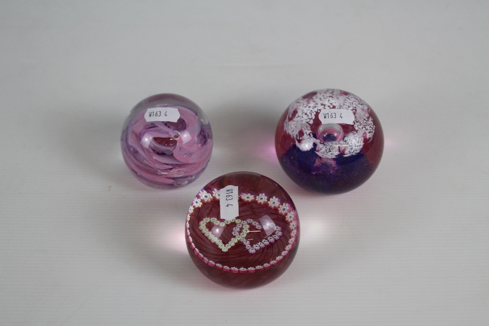 An Alum Bay (Isle of White) purple paperweight and two CG Caithness paperweights