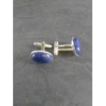 A pair of white metal and Lapis Lasuli cuff-links, with oval cabochons 2cm