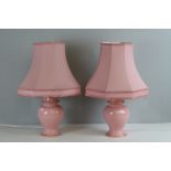Pair of pink pottery baluster shaped electric table lamps with pink shades