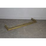 A Victorian brass fender, with three twisted rails and moulded base 130cm
