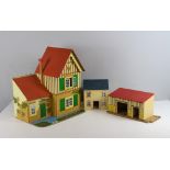 A vintage Tri-ang dolls house, and a selection of furniture and two other buildings 44cm x 42cm