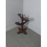 A modern mahogany four-tier plant stand, the turned central column issuing four branched stands,
