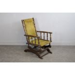 A Victorian American rocking chair, turned throughout with patterned green material back and seat