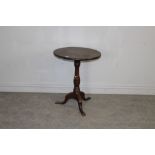 A George III mahogany stem table, the circular one-piece top above a baluster turned column and