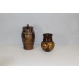 A studio pottery lidded storage jar, of ribbed baluster form with styled foliate decoration 33cm
