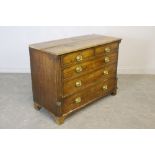 A George III oak chest of drawers, the moulded rectangular top above two short and three ling