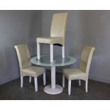 A modern circular glass topped pedestal table (74cm x 100cm) and three cream leather effect dining
