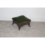A cast-iron based footstool, square section, cast and pierced with foliate scrolls 20cm x 35cm