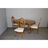 An elm twin-pedestal dining table and three chairs, in the 19th century style, table 76cm x 256cm