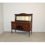 A 1920's mahogany mirror-back sideboard, the arched mirror back with swag decoration and turned