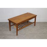 A 1970's teak coffee table, the rectangular top above a slatted under tier, unmarked but possibly