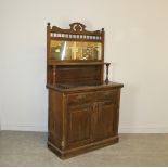 An Edwardian walnut mirror-back sideboard, with shaped and pierced surmount and spindle frieze 182cm