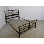 A 1920's mahogany double bed, in the Chippendale style, with rails and base 103cm x 136cm x 197cm