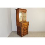 A 19th century oak narrow secretaire bookcase, with moulded cornice over two arched glazed doors and