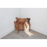 A canvas and leather fishing bag 41cm, containing a hand-knotted cotton fishing net